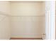Walk-in closet features neutral carpet and walls, complemented by minimalist metal shelving for organization at 3585 Berkeley Park Ct, Duluth, GA 30096