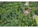 An aerial view shows a large, wooded property with defined boundary lines at 7080 Driskell Cir, Cumming, GA 30041