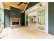 Back porch features a brick fireplace, sliding glass doors, and beautiful wooded views at 7080 Driskell Cir, Cumming, GA 30041