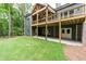 Spacious backyard with a covered porch, green lawn, and wooded surroundings, great for entertaining at 7080 Driskell Cir, Cumming, GA 30041