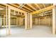 Large unfinished basement space ready for customization, featuring exposed beams and insulation at 7080 Driskell Cir, Cumming, GA 30041