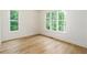 Serene bedroom bathed in natural light through two expansive windows at 7080 Driskell Cir, Cumming, GA 30041