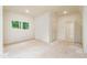 A bright bedroom features a window with nature views, white walls, and a neutral floor at 7080 Driskell Cir, Cumming, GA 30041