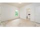 Spacious bedroom with white walls with a window view and access to a bathroom at 7080 Driskell Cir, Cumming, GA 30041
