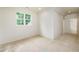 An unfinished bedroom displays a window and freshly painted white walls, creating a bright and airy atmosphere at 7080 Driskell Cir, Cumming, GA 30041