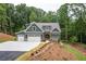 Picturesque home displaying a three-car garage and a well-maintained landscape at 7080 Driskell Cir, Cumming, GA 30041