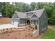 Attractive home featuring a three-car garage and professional landscaping at 7080 Driskell Cir, Cumming, GA 30041