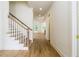 Bright foyer showcasing hardwood floors, a staircase, and views into other living spaces at 7080 Driskell Cir, Cumming, GA 30041