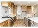 Chef's kitchen with professional range, large island, and stainless appliances at 7080 Driskell Cir, Cumming, GA 30041