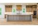 Modern kitchen features an oversized island, designer finishes, and lighting at 7080 Driskell Cir, Cumming, GA 30041