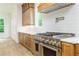 Stylish kitchen with stainless steel range, custom cabinetry, and backsplash at 7080 Driskell Cir, Cumming, GA 30041