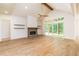 Spacious living room with vaulted ceilings, a stone fireplace, and outdoor access at 7080 Driskell Cir, Cumming, GA 30041