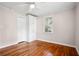 Bedroom featuring hardwood floors, a closet, a window, and a ceiling fan at 1891 8Th St, Atlanta, GA 30341