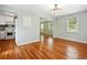 Dining room adjacent to kitchen with hardwood floors, light walls, and windows at 1891 8Th St, Atlanta, GA 30341