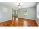 Dining room with hardwood floors, light walls, a classic ceiling light, and three windows at 1891 8Th St, Atlanta, GA 30341