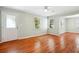 Living room with hardwood floors, two windows, light walls, and a door at 1891 8Th St, Atlanta, GA 30341