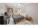 Comfortable bedroom with neutral walls, a decorative floral bedspread, and ample natural light at 244 Timber Creek Sw Ln, Marietta, GA 30060