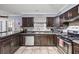 Spacious kitchen with dark wood cabinets, stainless steel appliances, and tile flooring at 244 Timber Creek Sw Ln, Marietta, GA 30060