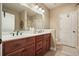Bathroom featuring double sink vanity, a large mirror, and a tiled shower and tub area with a neutral color palette at 3286 Crawford Cir, Marietta, GA 30066