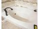 Relaxing white bathtub with tile accents and stylish fixtures, perfect for unwinding after a long day at 3286 Crawford Cir, Marietta, GA 30066