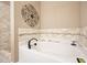 White bathtub with stone tile backsplash and adjacent tiled shower, perfect for relaxation at 3286 Crawford Cir, Marietta, GA 30066