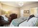Cozy bedroom featuring warm neutral tones, a plush leather chair, and a comfortable bed with stylish accents at 3286 Crawford Cir, Marietta, GA 30066