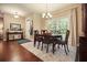 Bright dining room with a wooden table, six chairs, a large window, and modern chandelier at 3286 Crawford Cir, Marietta, GA 30066