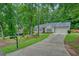 Well-maintained home featuring a long driveway, lush lawn, and attractive landscaping at 3286 Crawford Cir, Marietta, GA 30066