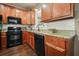 Close-up of kitchen with black appliances and granite countertops with a white tile backsplash at 3286 Crawford Cir, Marietta, GA 30066
