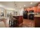Well-lit kitchen with dark wood floors, a large island with bar stool seating, and black appliances at 3286 Crawford Cir, Marietta, GA 30066