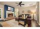 Cozy living room with a fireplace, stone hearth, leather sofa, and accent wall with decorative wall art at 3286 Crawford Cir, Marietta, GA 30066