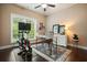 Bright home office with hardwood floors, exercise bike, natural light, and a functional workspace at 3286 Crawford Cir, Marietta, GA 30066