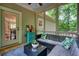 Relaxing screened patio with comfortable seating, glass table, and views of the lush, surrounding greenery at 3286 Crawford Cir, Marietta, GA 30066