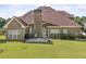 Spacious backyard with patio and well-manicured lawn and brick home at 2900 Sutton Pl, Conyers, GA 30013