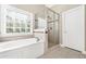 This bathroom features a soaking tub and glass-enclosed shower at 2900 Sutton Pl, Conyers, GA 30013