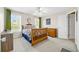 This bedroom features neutral walls, a wooden bedframe, and green curtains at 2900 Sutton Pl, Conyers, GA 30013