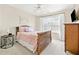 This bedroom features neutral walls, a wooden bedframe, and a side table at 2900 Sutton Pl, Conyers, GA 30013