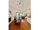 Combination dining and work space includes hardwood flooring, large fireplace and bright light at 2900 Sutton Pl, Conyers, GA 30013