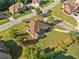 An aerial view of the home with a lush lawn, mature trees and landscaping at 2900 Sutton Pl, Conyers, GA 30013