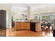 Open kitchen with wooden cabinets, black appliances, and an adjacent dining area at 2900 Sutton Pl, Conyers, GA 30013