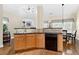 Bright kitchen with stainless steel sink, dark countertops, and a black dishwasher at 2900 Sutton Pl, Conyers, GA 30013