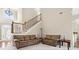 Cozy living room with staircase, high ceilings, and lots of natural light at 2900 Sutton Pl, Conyers, GA 30013