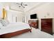 This main bedroom features a tray ceiling, ceiling fan, and coordinating furniture with light carpeting at 2900 Sutton Pl, Conyers, GA 30013