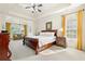 Spacious main bedroom features a large bed, carpeted floor, and bright natural light at 2900 Sutton Pl, Conyers, GA 30013
