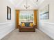 This sitting room features an accent wall, neutral paint, and a window for natural light at 2900 Sutton Pl, Conyers, GA 30013