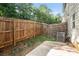 Fenced backyard offers privacy with a small concrete patio for outdoor relaxation at 2909 Emme Ct, Conyers, GA 30094