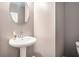 Features a pedestal sink with stylish faucet and a round mirror at 2909 Emme Ct, Conyers, GA 30094