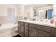 Modern bathroom with double vanity, a soaking tub, and tiled shower at 2909 Emme Ct, Conyers, GA 30094