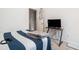 Cozy bedroom featuring striped bedding, small desk with TV, and an open doorway at 2909 Emme Ct, Conyers, GA 30094