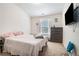 Bright bedroom with a window, TV, and carpeted floors at 2909 Emme Ct, Conyers, GA 30094